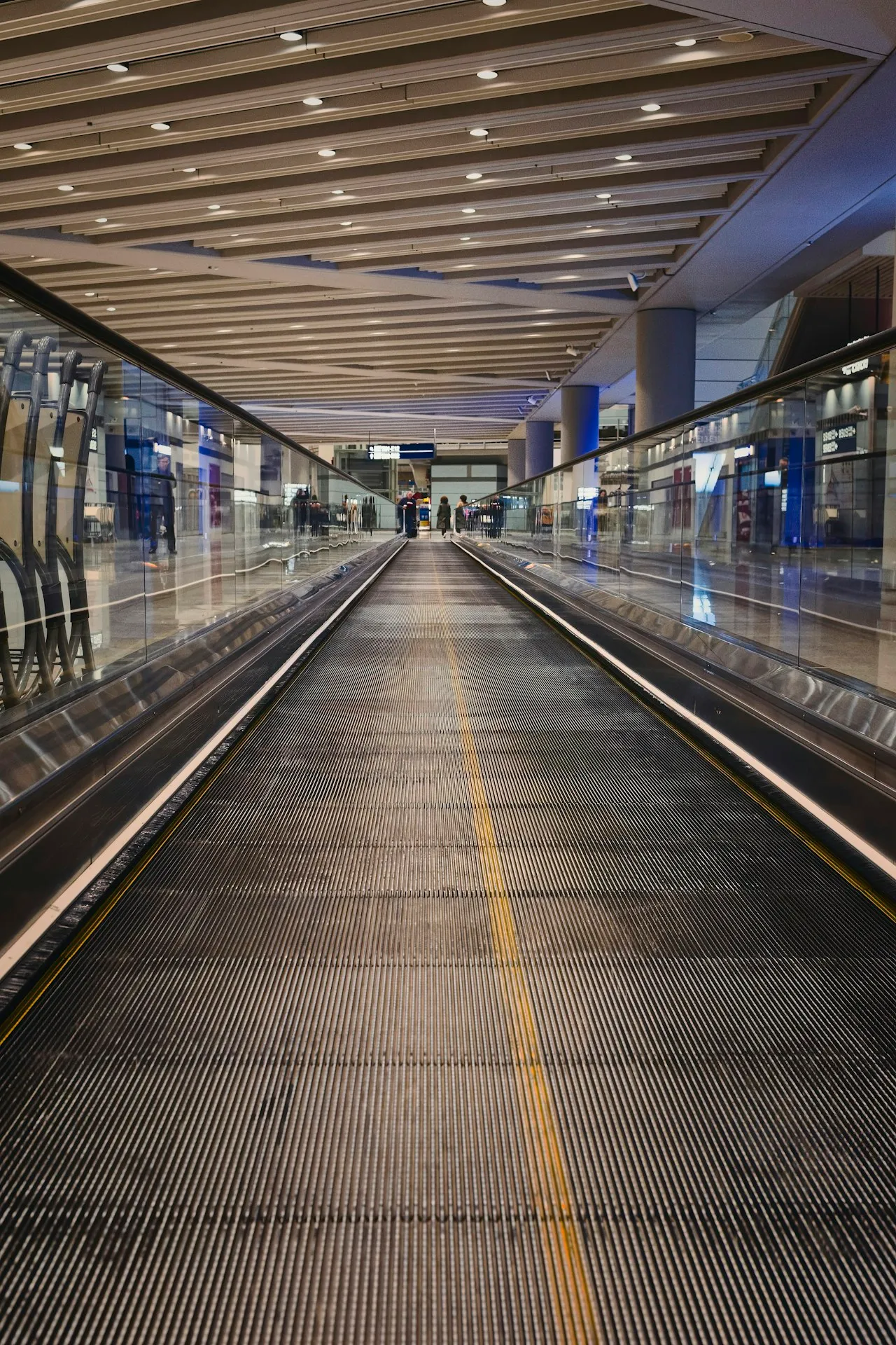 Moving walkway stretching through a modern airport terminal corridor